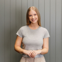 Samantha standing in front of a grey background